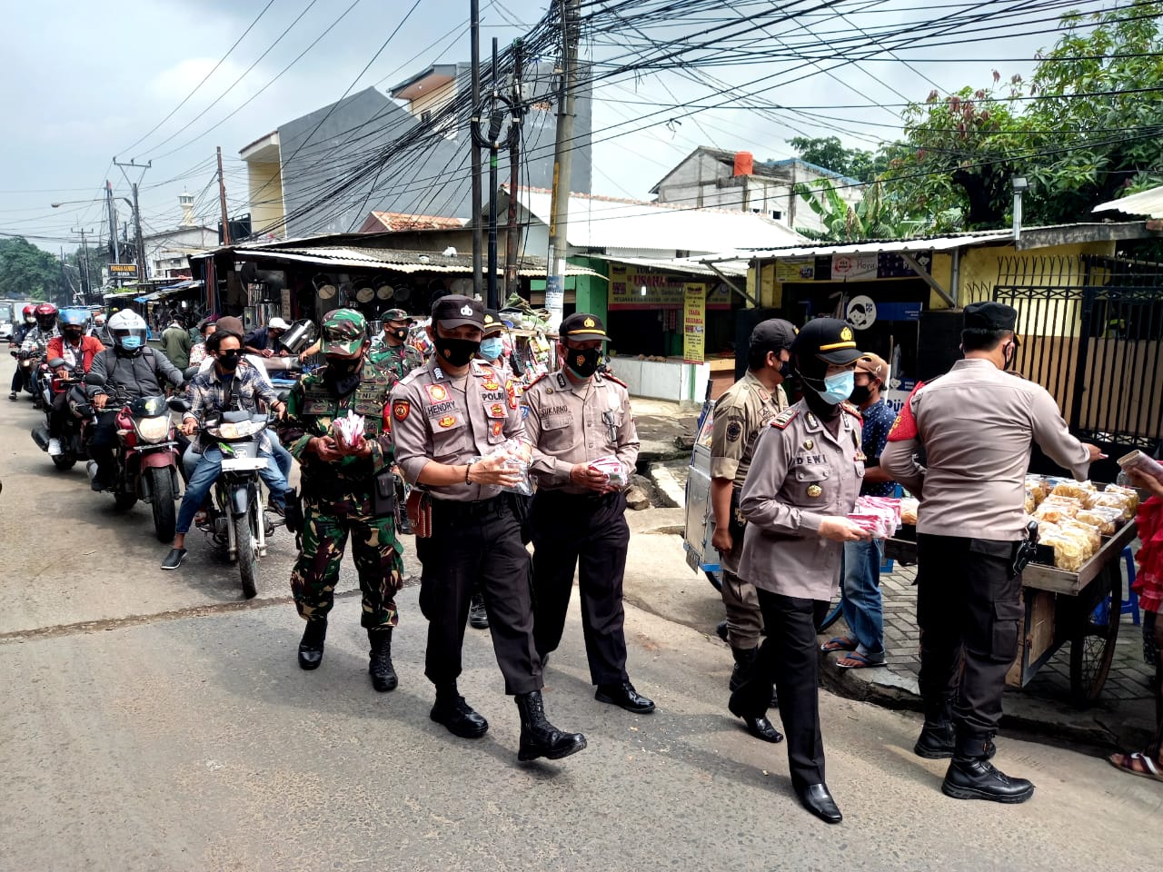 Polsek Medan Satria bersama Tiga Pilar memberikan imbauan dan masker kepada masyarakat. (Foto: PMJ News). 