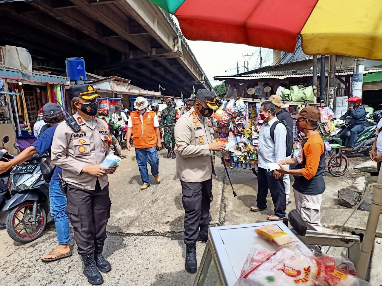 Polisi bagikan masker sekaligus berikan imbauan prokes 4 M kepada pedagang. (Foto: PMJ News). 