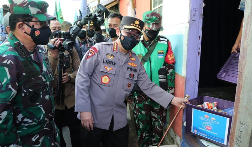 Kapolri Jenderal Listyo Sigit Prabowo bersama Panglima TNI menyerahkan bansos bagi masyarakat. (Foto: PMJ News).