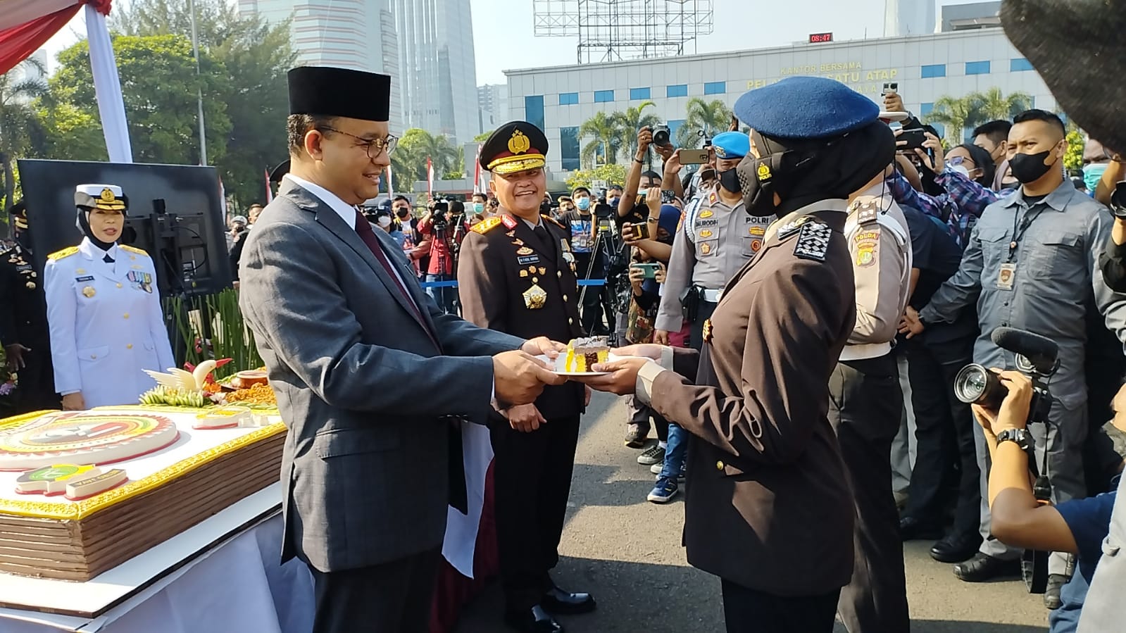Kapolda Metro Jaya dan Gubernur DKI mendapat kue dan nasi kuning di HUT Bhayangkara ke-76. (Foto: PMJ/Fajar). 
