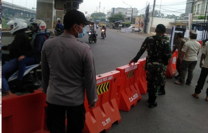 Petugas gabungan berjaga di Pos Penyekatan Sumber Artha Bekasi. (Foto: PMJ News).