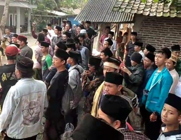 Warga menyaksikan pengepungan DPO pencabulan diamankan polisi. (Foto: Dok Net)